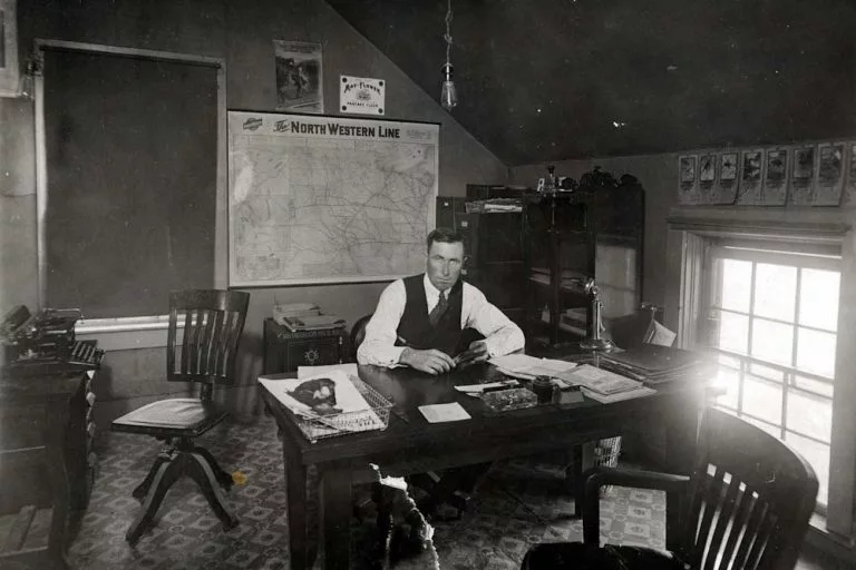 John Campbell behind a desk